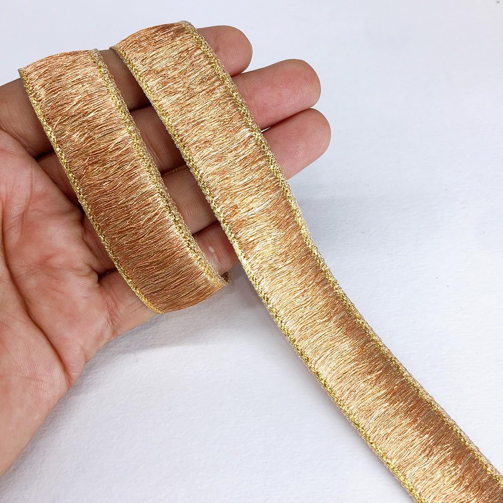 24 mm Thick Gold Metallic Zari Ribbon, shown on white cotton