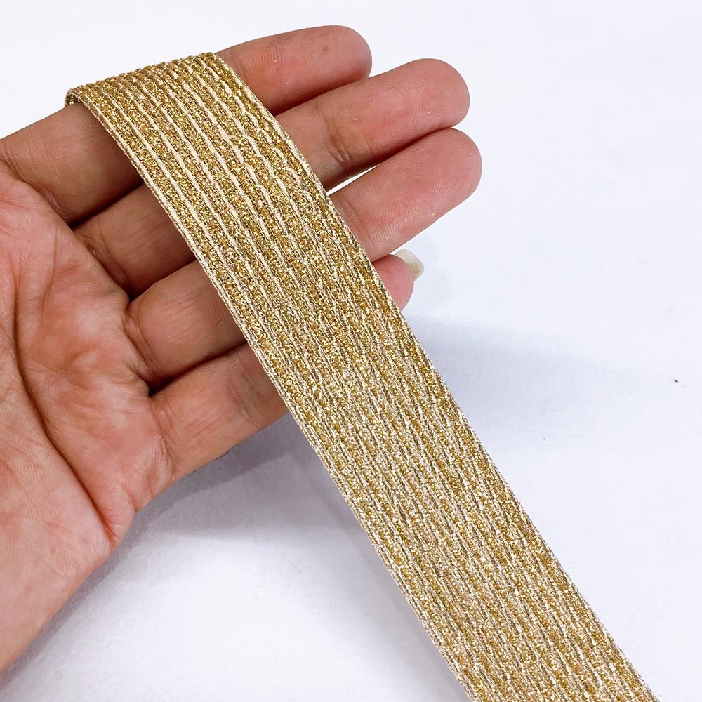 25mm Metallic Ribbon with 10 Embossed Gold Zari Cords, shown on white cotton