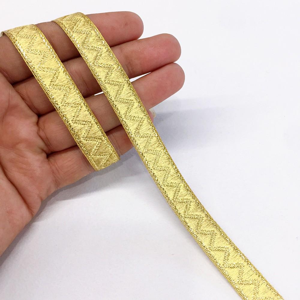 14 mm Thick Gold Metallic Zari Zig-Zag Embossed Ribbon, shown on white cotton