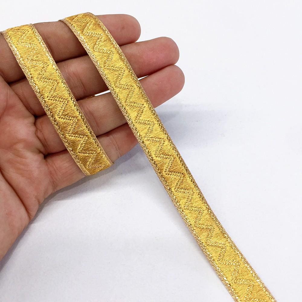 14 mm Thick Gold Metallic Zari Zig-Zag Embossed Ribbon, shown on white cotton