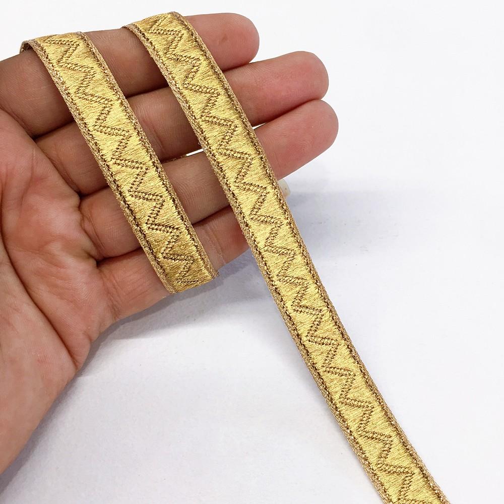 14 mm Thick Gold Metallic Zari Zig-Zag Embossed Ribbon, shown on white cotton