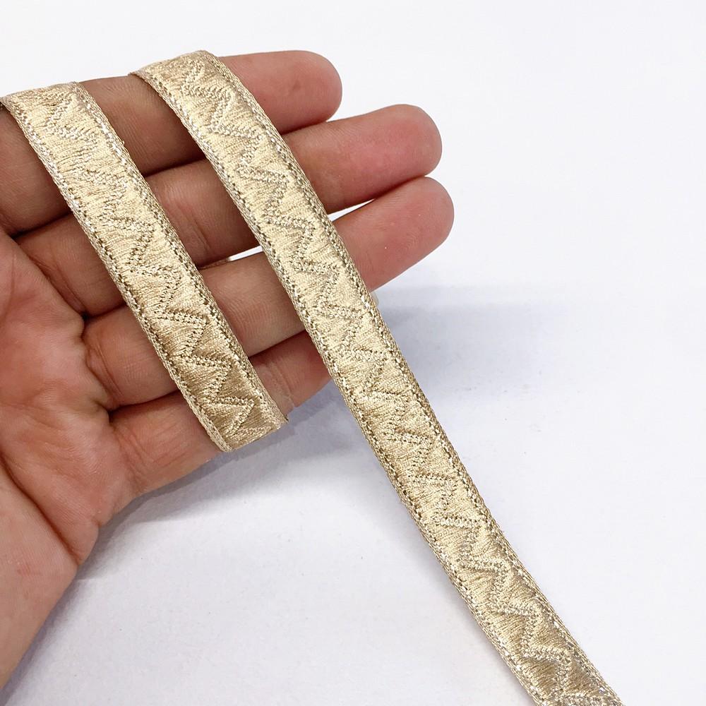 14 mm Thick Gold Metallic Zari Zig-Zag Embossed Ribbon, shown on white cotton