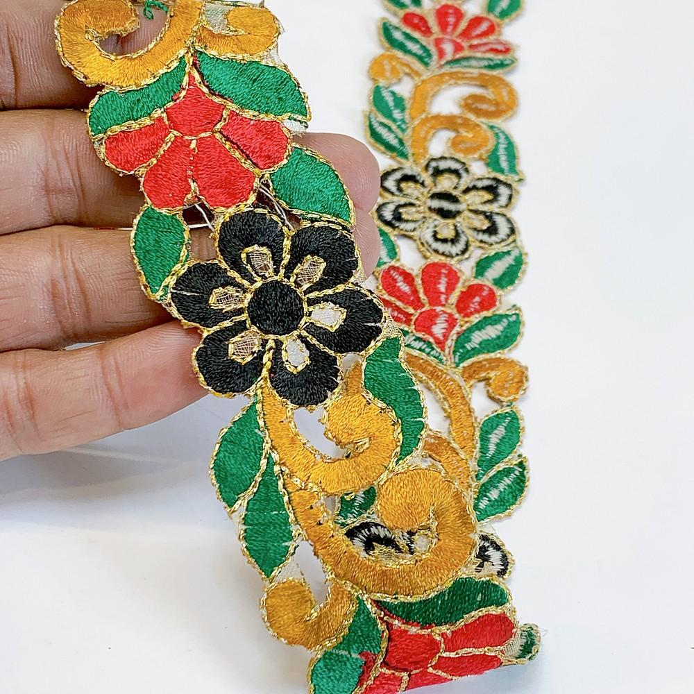 25mm Designer Cutwork Embroidery Lace, shown on white cotton