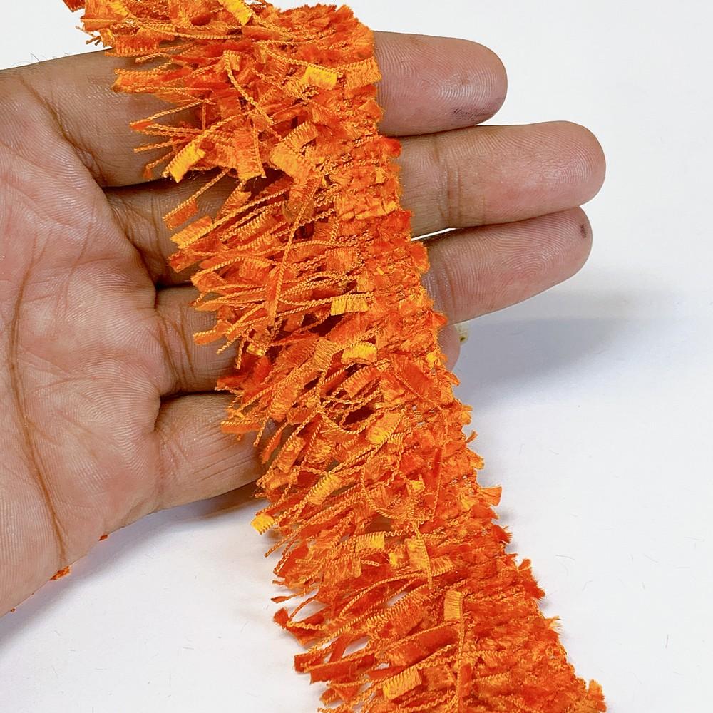 40mm Light Orange Designer Polyester Fringe, shown on white cotton