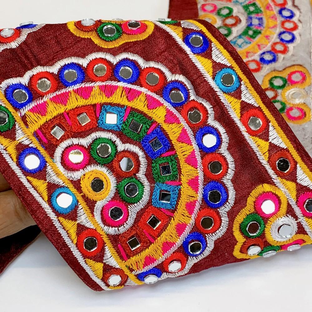 110mm Designer Kutchi Multicolour Embroidery Lace With Mirror Work, shown on white cotton