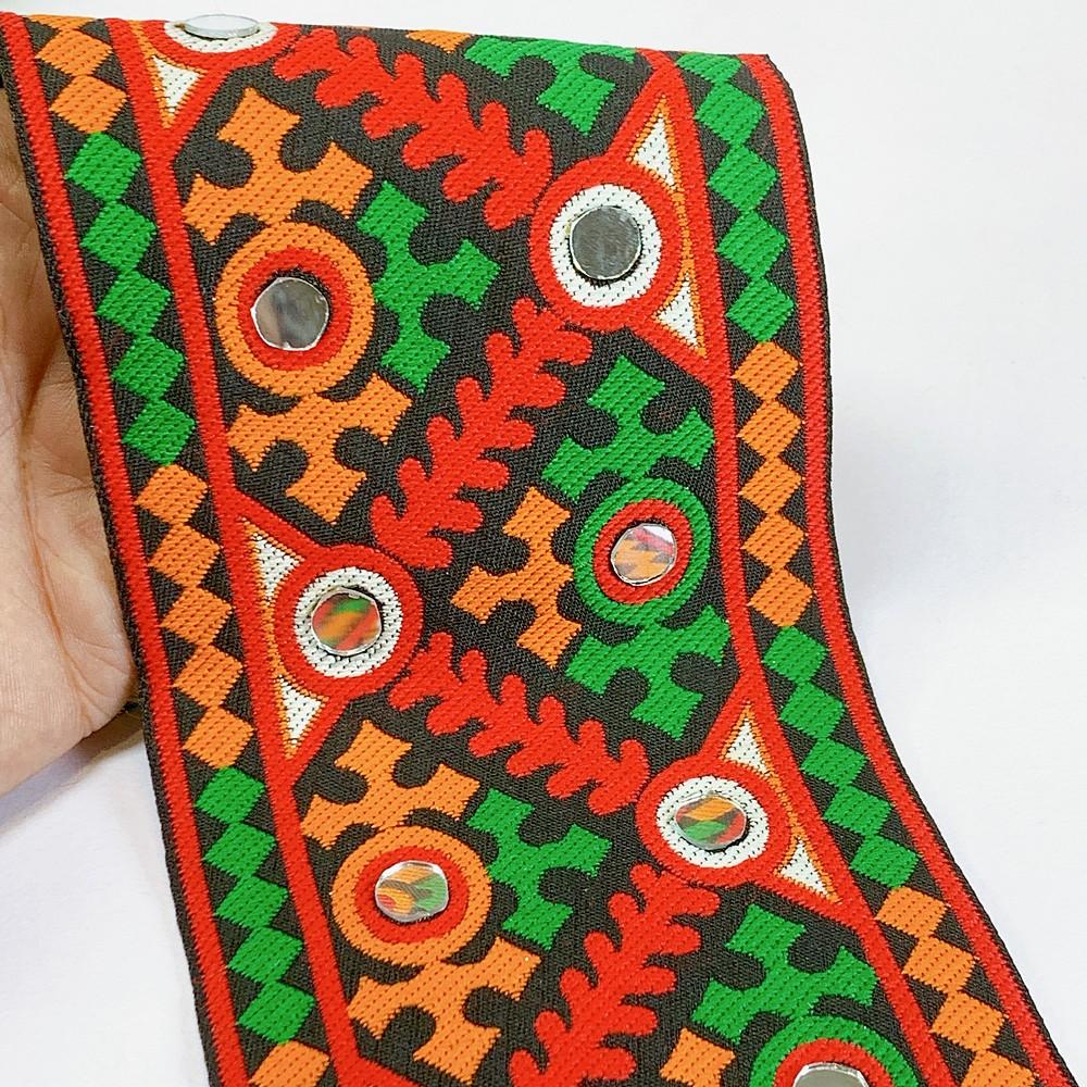 100mm Kutchi Design Jacquard Lace With Mirror Work, shown on white cotton