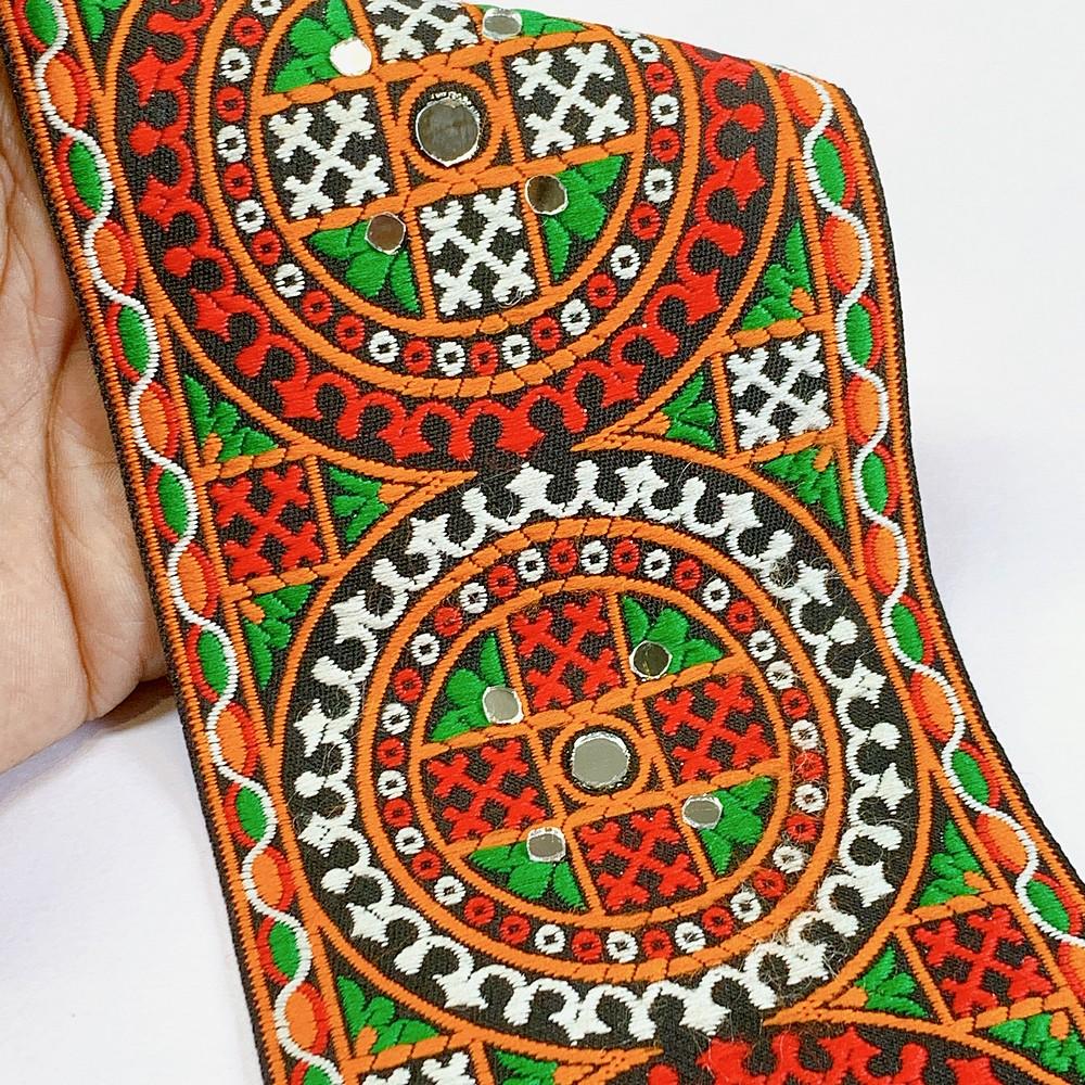 100mm Kutchi Design Jacquard Lace With Mirror Work, shown on white cotton