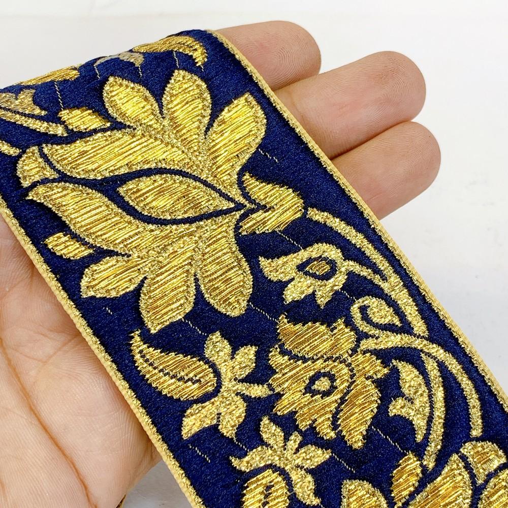 57 mm Designer Jacquard Lace With Golden Zari Thread Work, shown on white cotton
