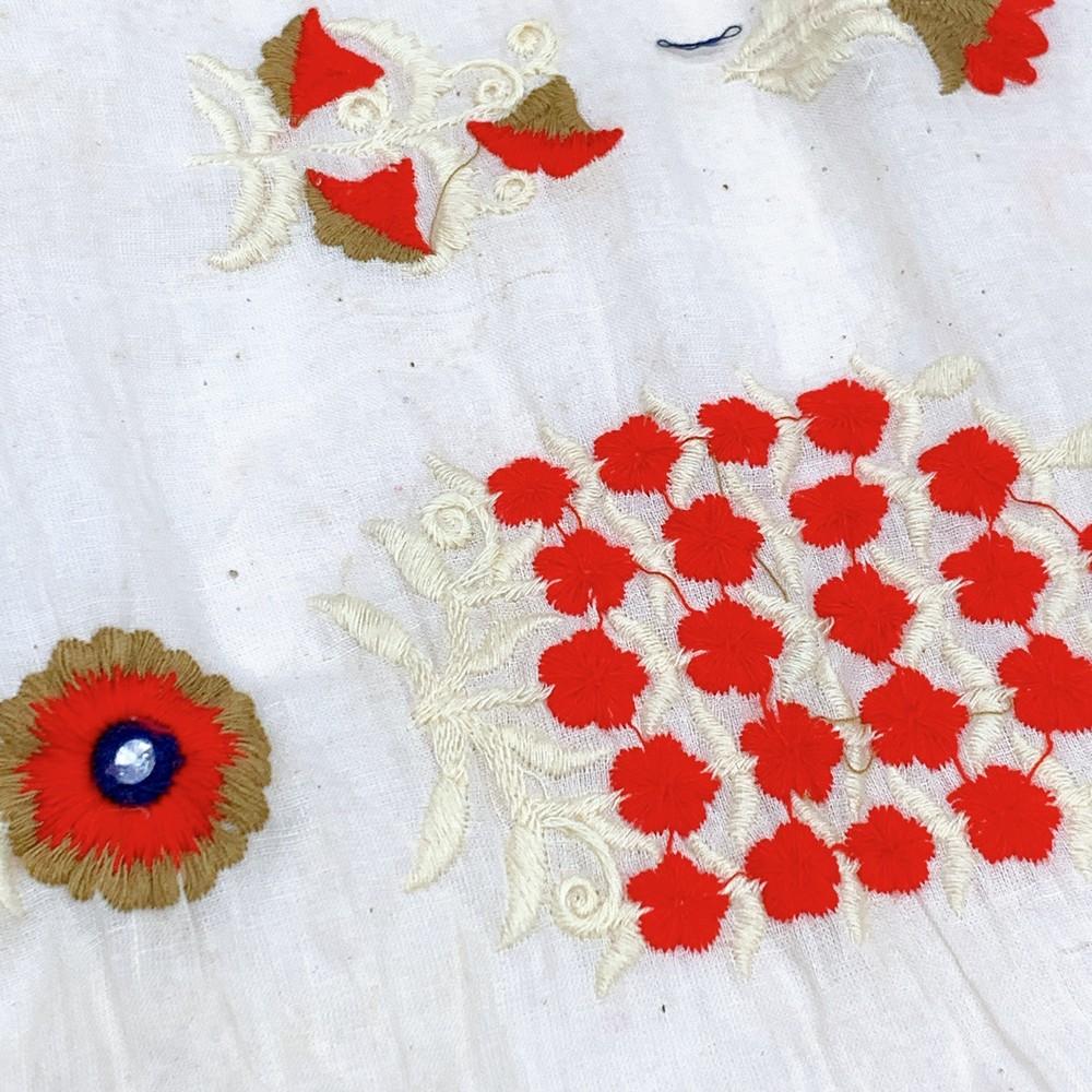 Embroidery Work On Cotton Fabric, shown on white cotton