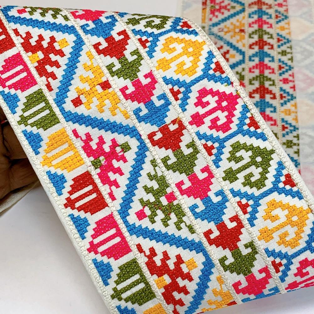 Lami 104 mm Designer Crossstitch Embroidery Lace, shown on white cotton