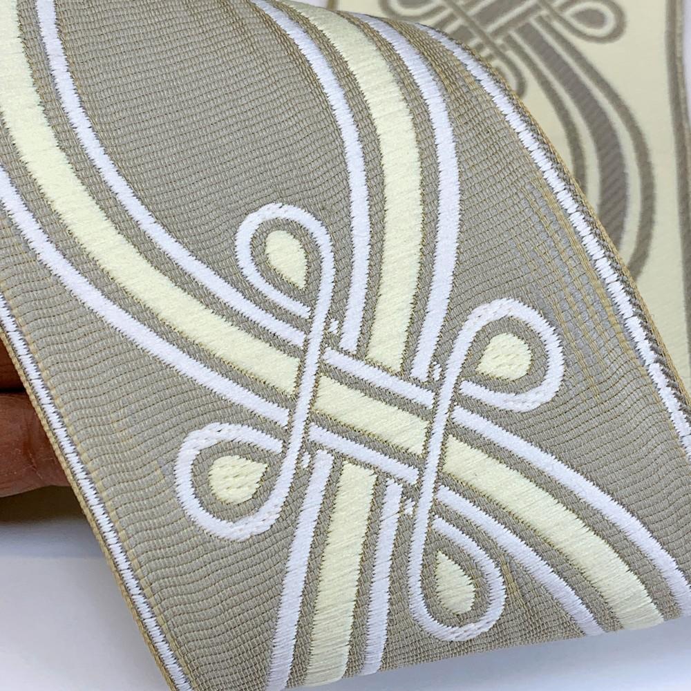 90mm Ornate Loop Design Tapestry Trim, shown on white cotton