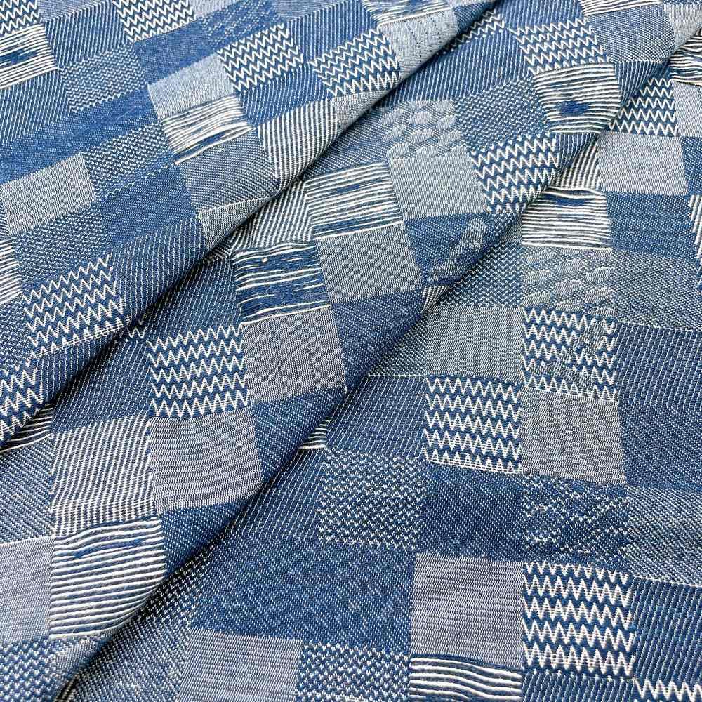 9oz Blue Distressed Grid Patchwork Jacquard Denim Fabric, shown on white cotton
