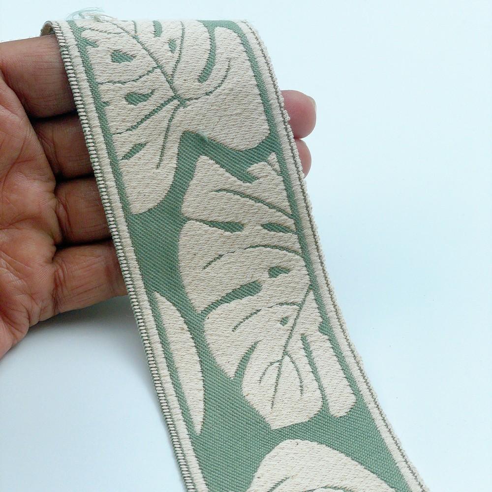 58mm Wide Tropical Monstera Leaf Pattern Lace Border for Sewing, Garments, DIY Crafts & Home Decor, shown on white cotton