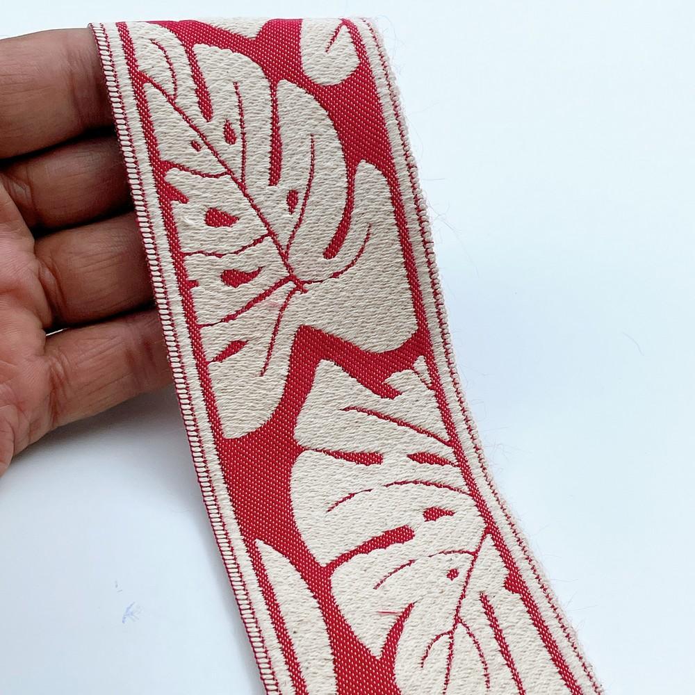 58mm Wide Tropical Monstera Leaf Pattern Lace Border for Sewing, Garments, DIY Crafts & Home Decor, shown on white cotton