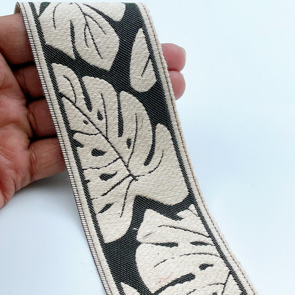 58mm Wide Tropical Monstera Leaf Pattern Lace Border for Sewing, Garments, DIY Crafts & Home Decor, shown on white cotton