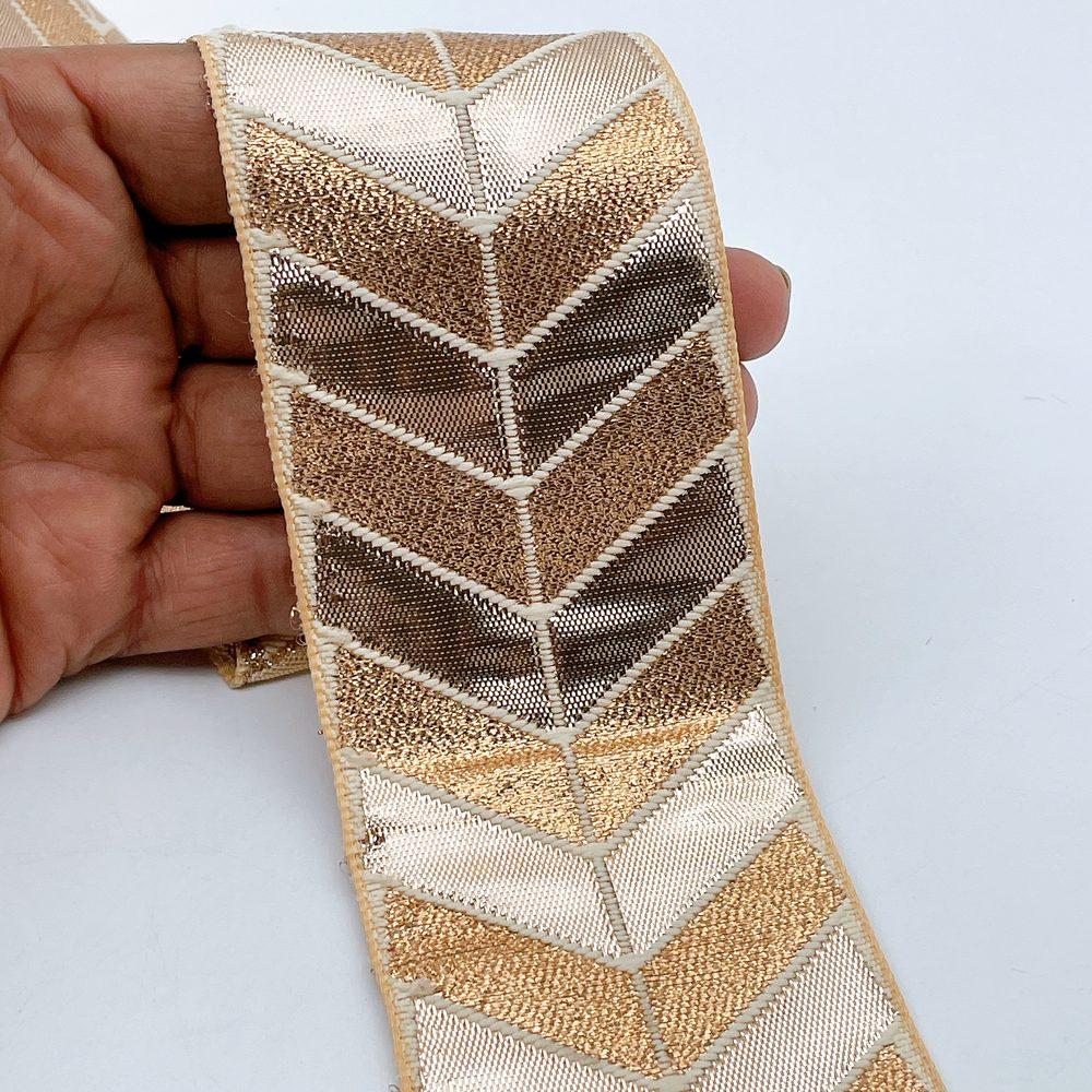 60mm Wide Gota Work Jacquard Ribbon - Metallic Chevron Border Lace, shown on white cotton