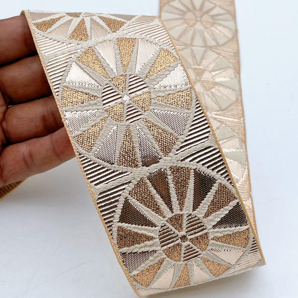 60mm Wide Gota Work Jacquard Ribbon - Metallic Sunburst Border, shown on white cotton