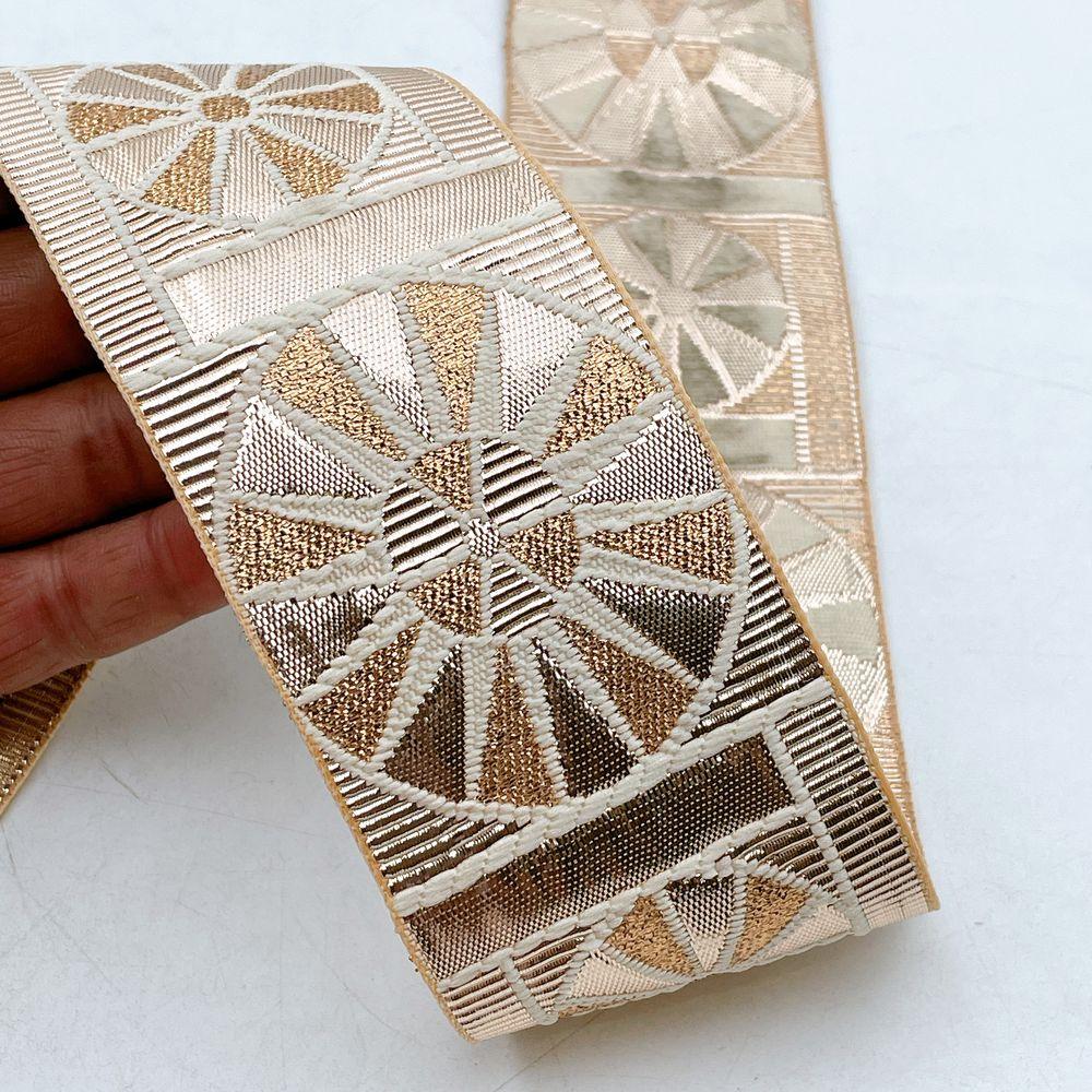60mm Wide Gota Work Jacquard Ribbon - Blocked Sunburst Border Lace, shown on white cotton