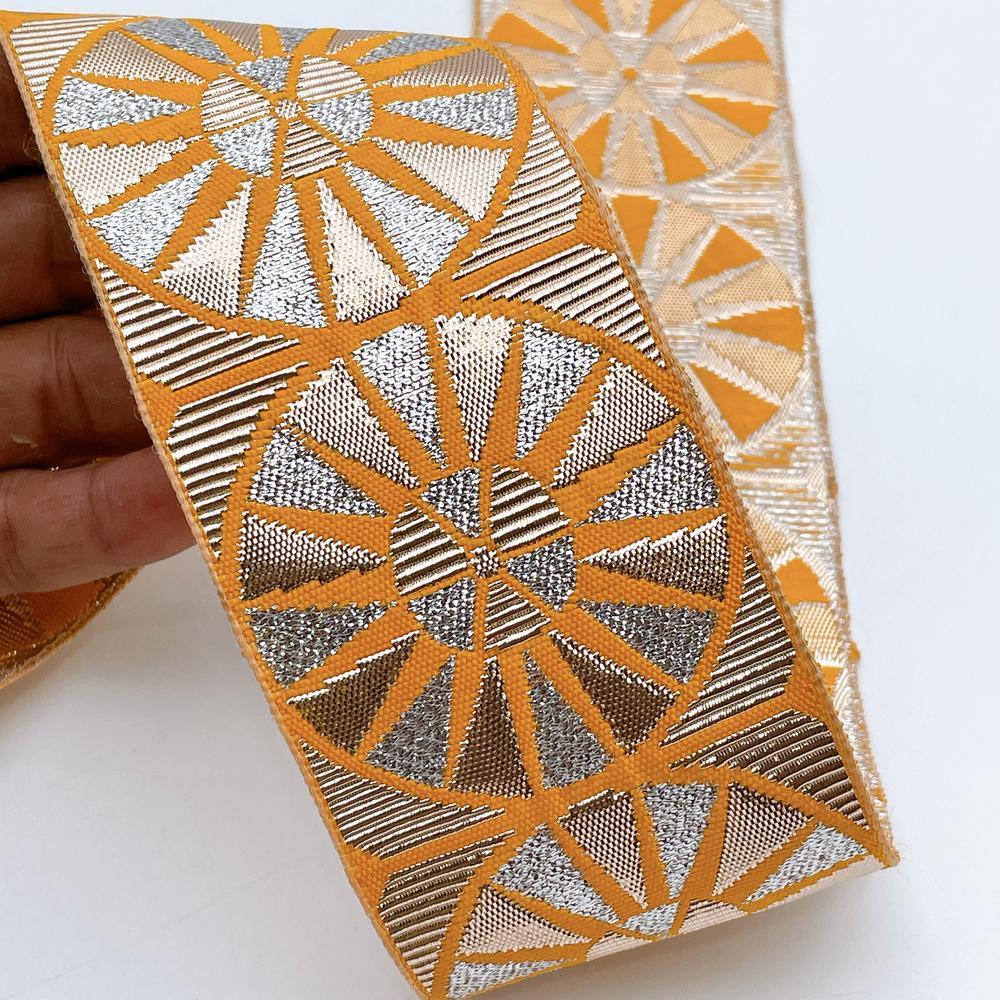 60mm Wide Colorful Sunburst Gota Work Jacquard Ribbon - Woven Border, shown on white cotton