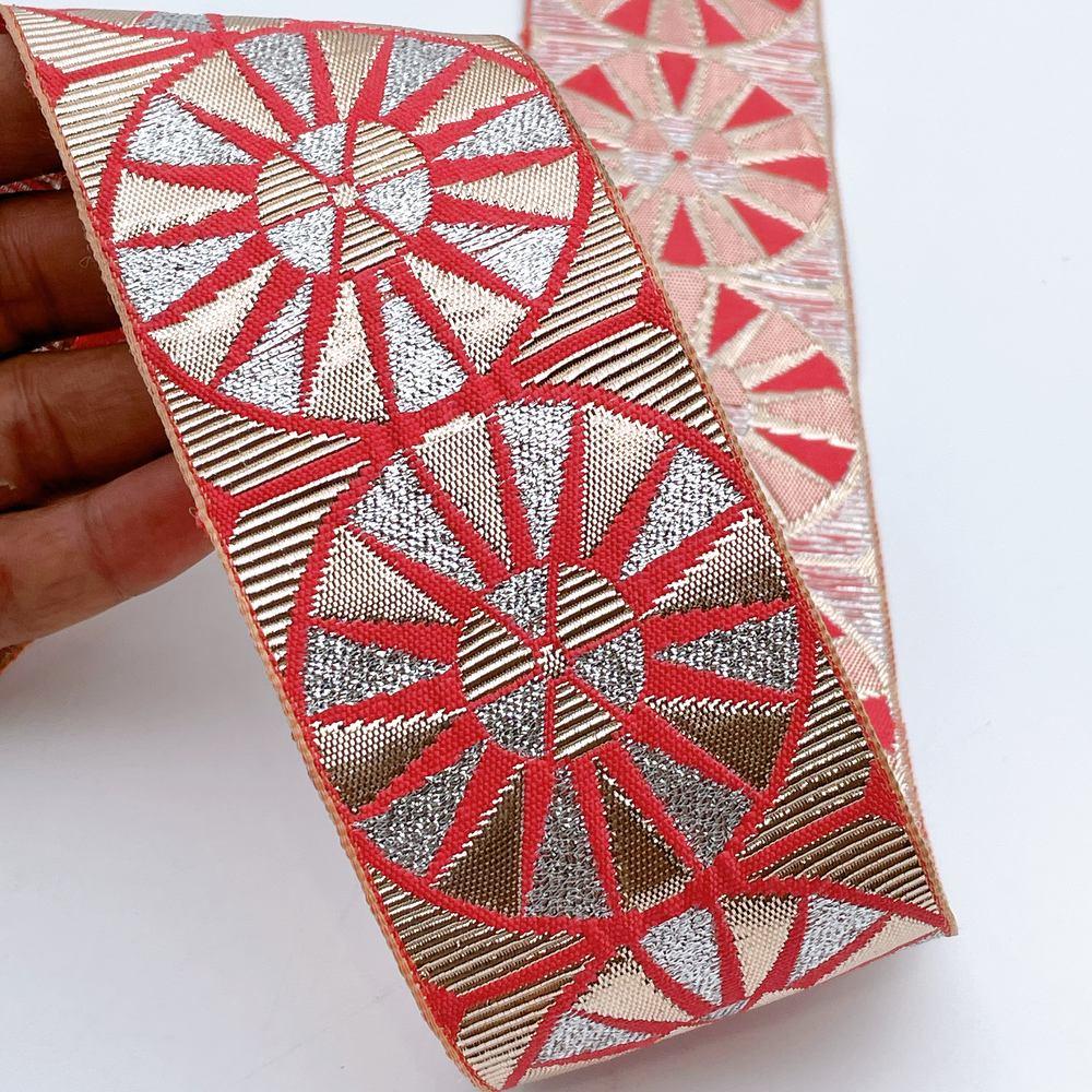 60mm Wide Colorful Sunburst Gota Work Jacquard Ribbon - Woven Border, shown on white cotton