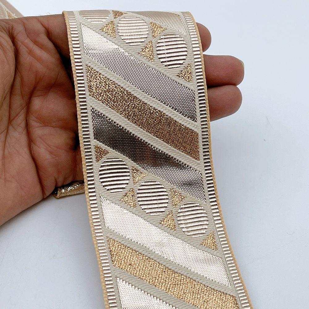 60mm Wide Gota Work Jacquard Ribbon - Geometric Circle & Stripe Border, shown on white cotton