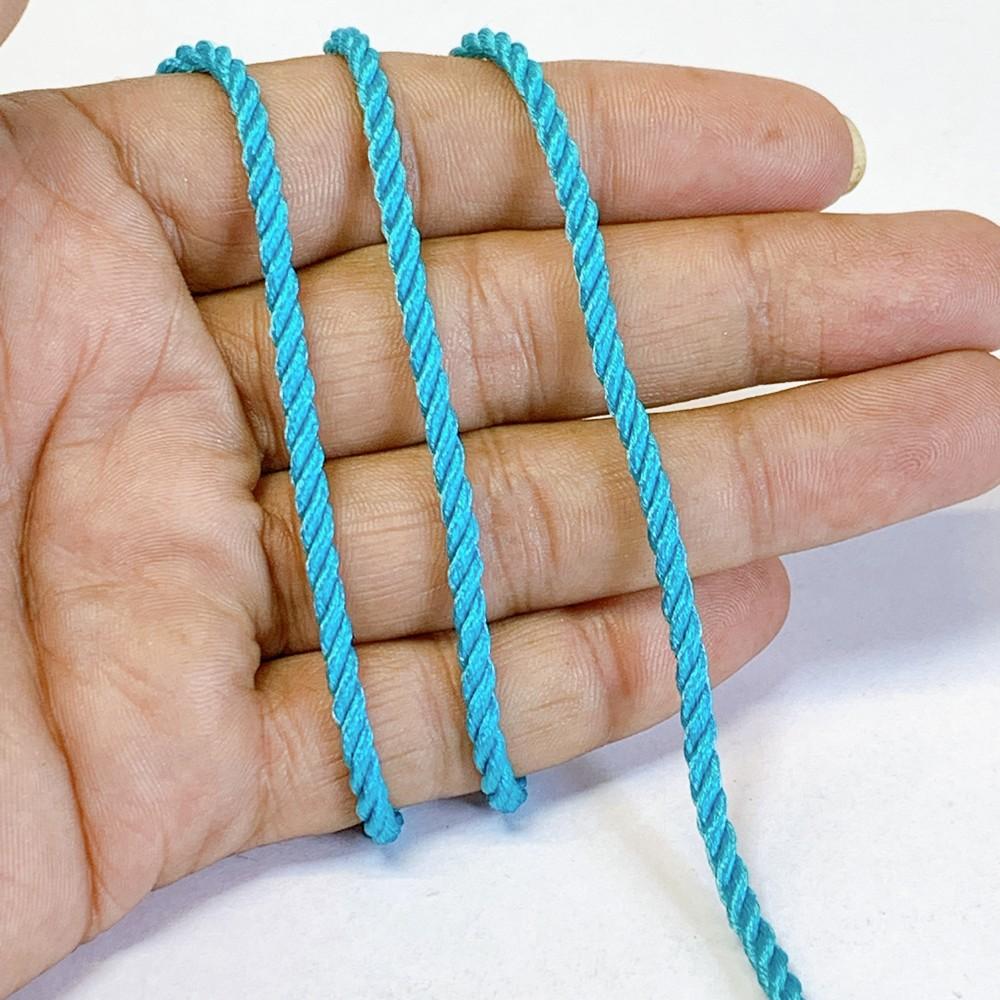 3mm Shiny Twisted Dori Cord - Multicolor Decorative Rope Trim for Apparel, Jewelry, and Macrame, shown on white cotton