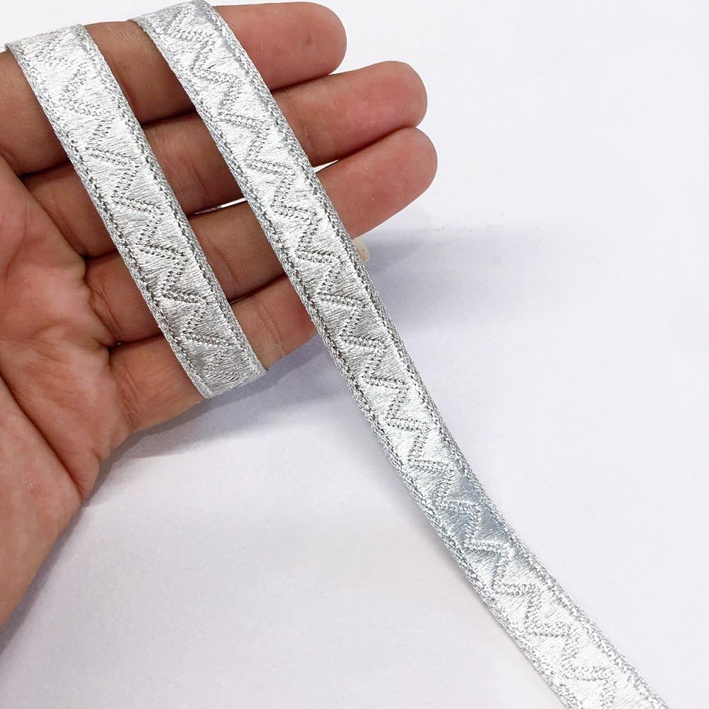 14 mm Thick Gold Metallic Zari Zig-Zag Embossed Ribbon, shown on white cotton