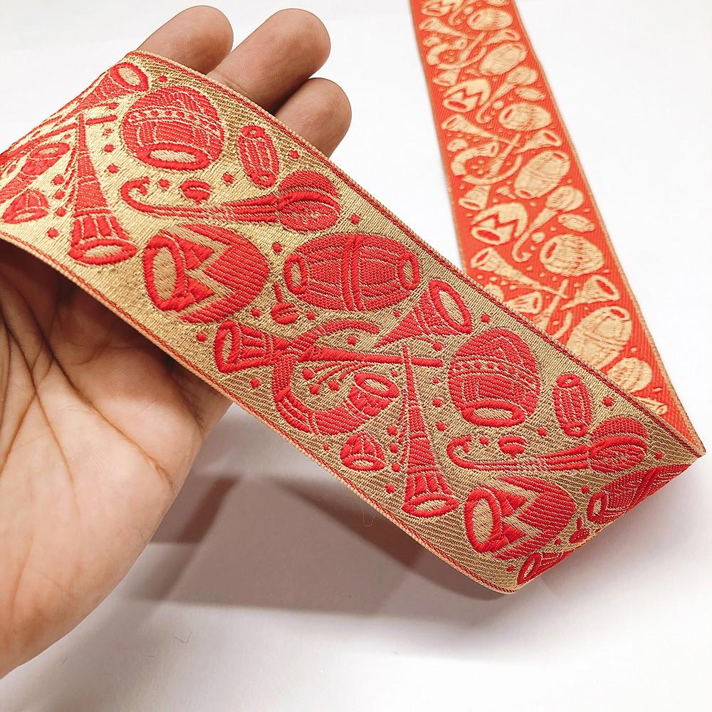 60mm Indian instruments Jacquard Ribbon, shown on white cotton