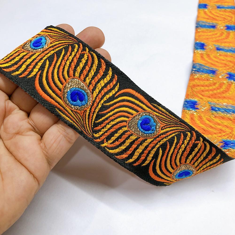 50mm peacock Feather Design Jacquard Lace, shown on white cotton