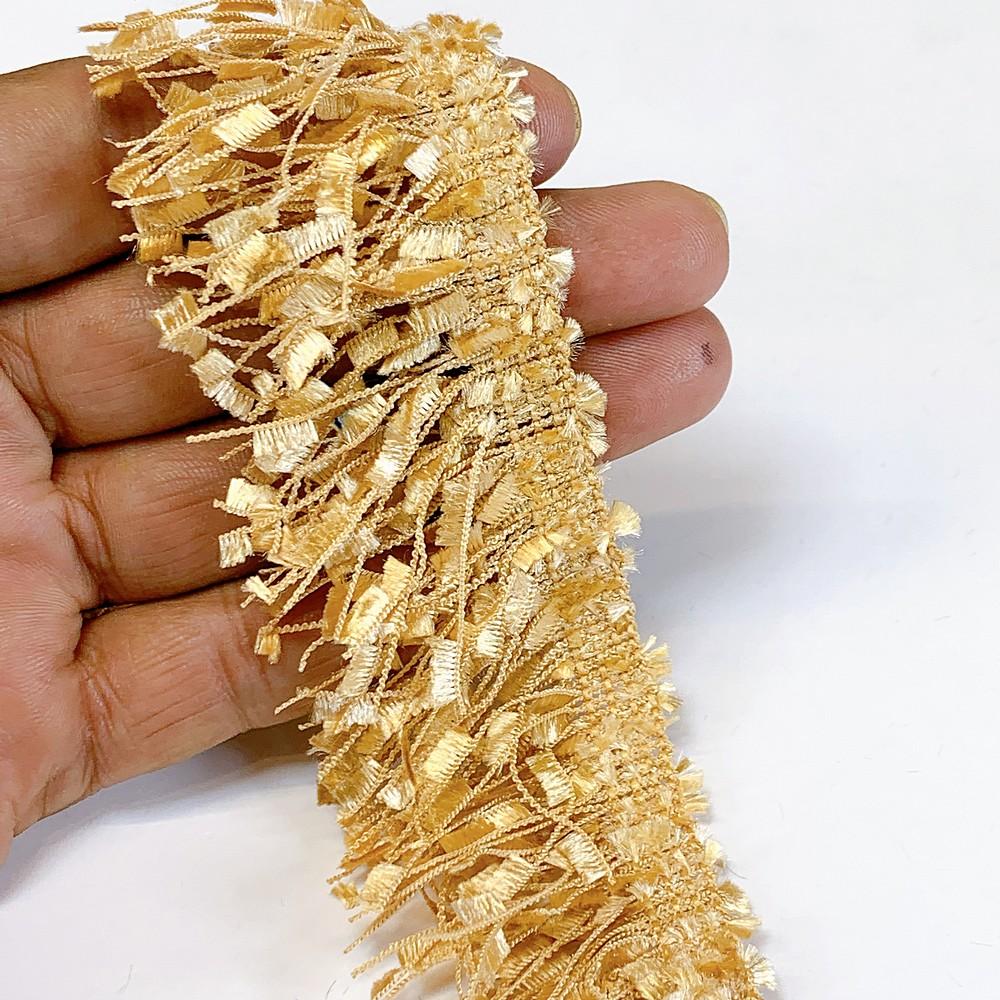40mm Light Orange Designer Polyester Fringe, shown on white cotton