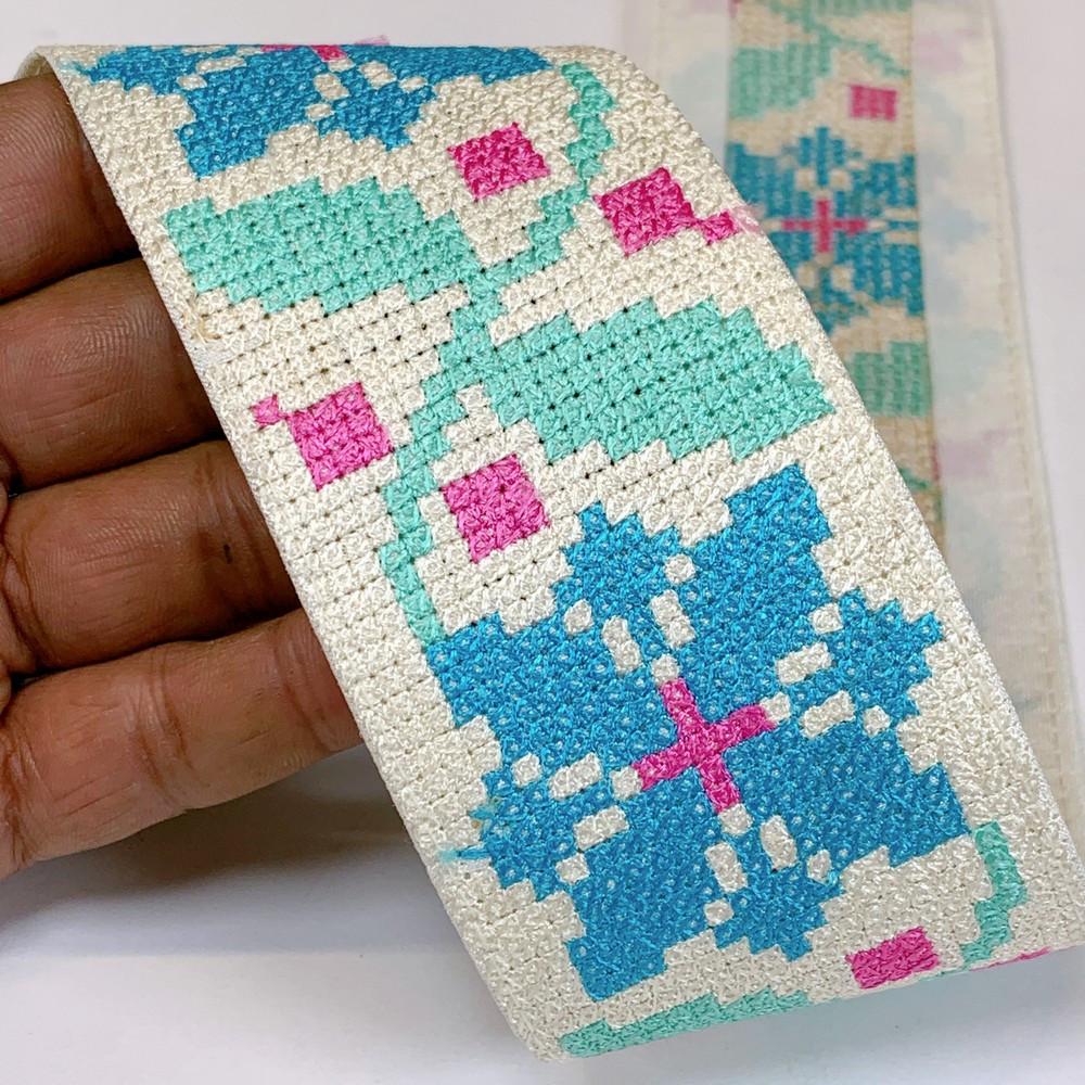 Lami 56 mm Designer Crossstitch Embroidery Lace, shown on white cotton