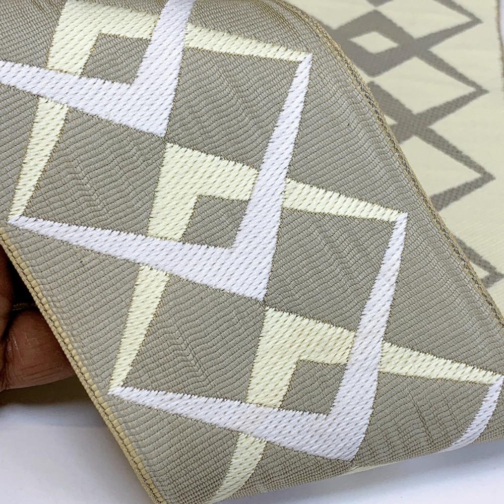 90mm Geometric Elegance Tapestry Tape, shown on white cotton