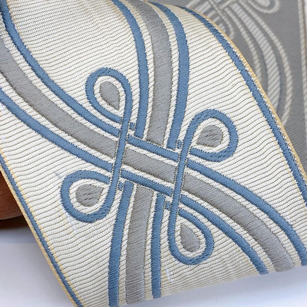 90mm Ornate Loop Design Tapestry Trim, shown on white cotton