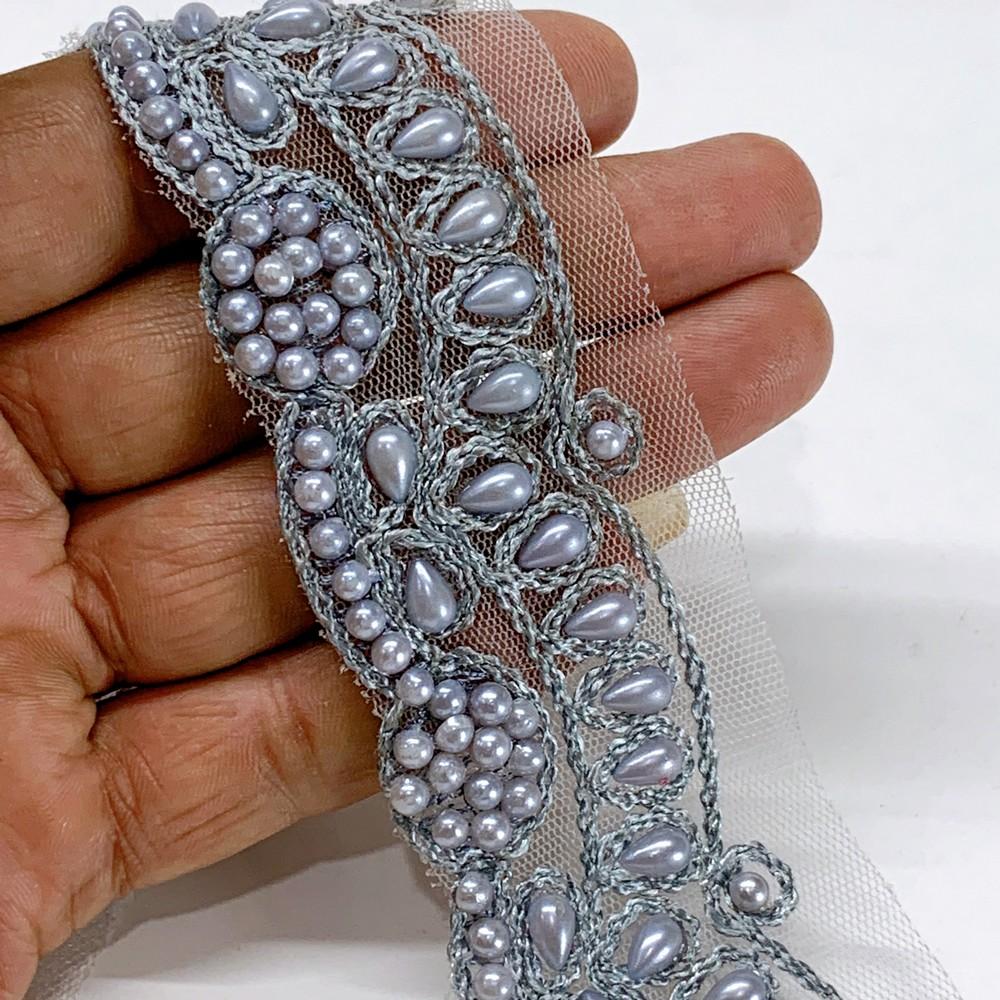 35mm Embroidered Beaded Lace Trim on Net, shown on white cotton