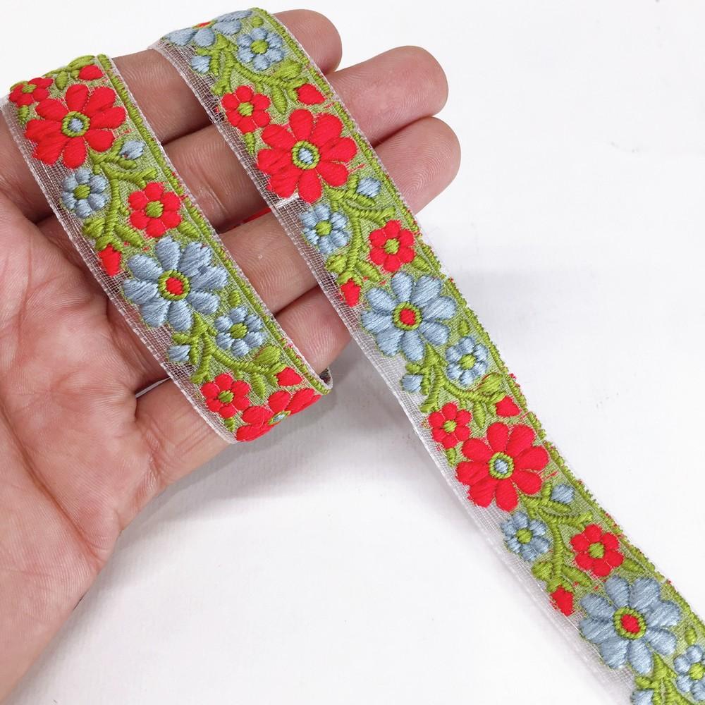 20mm Organza back flower creeper Jacquard trim, shown on white cotton