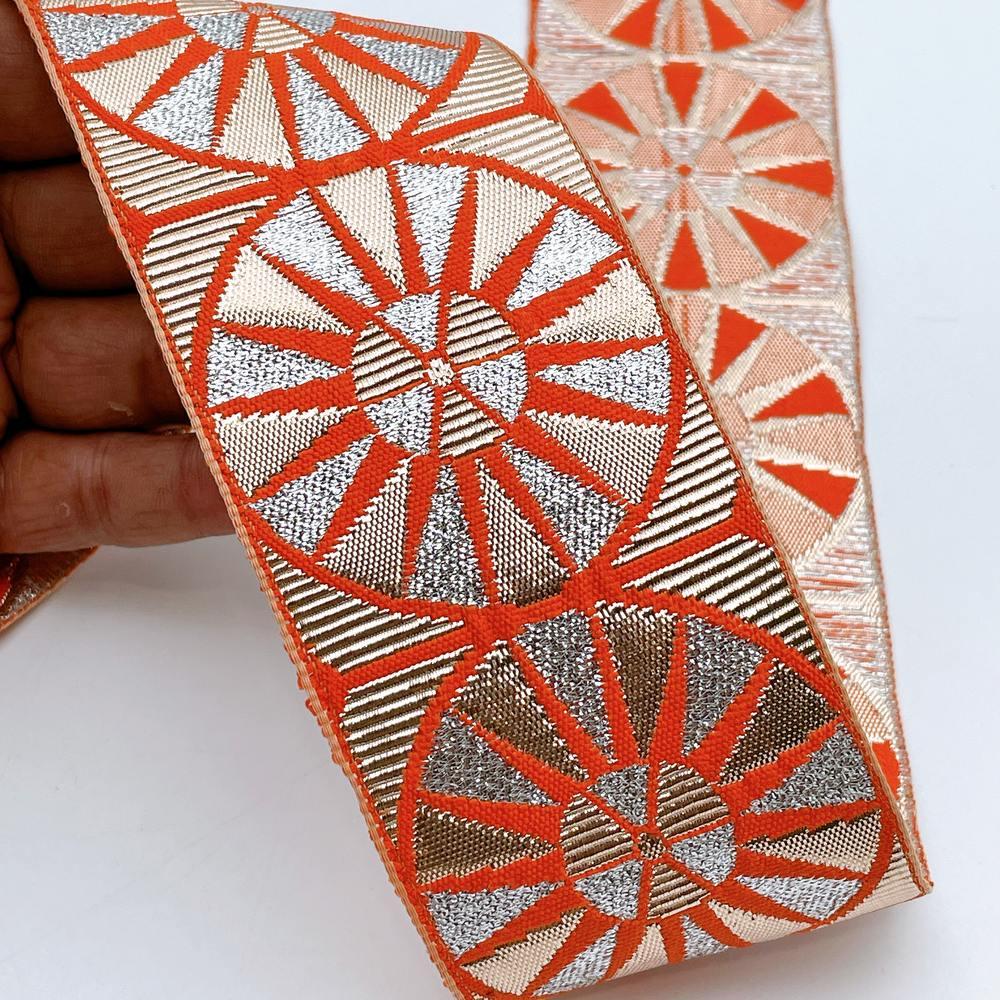 60mm Wide Colorful Sunburst Gota Work Jacquard Ribbon - Woven Border, shown on white cotton
