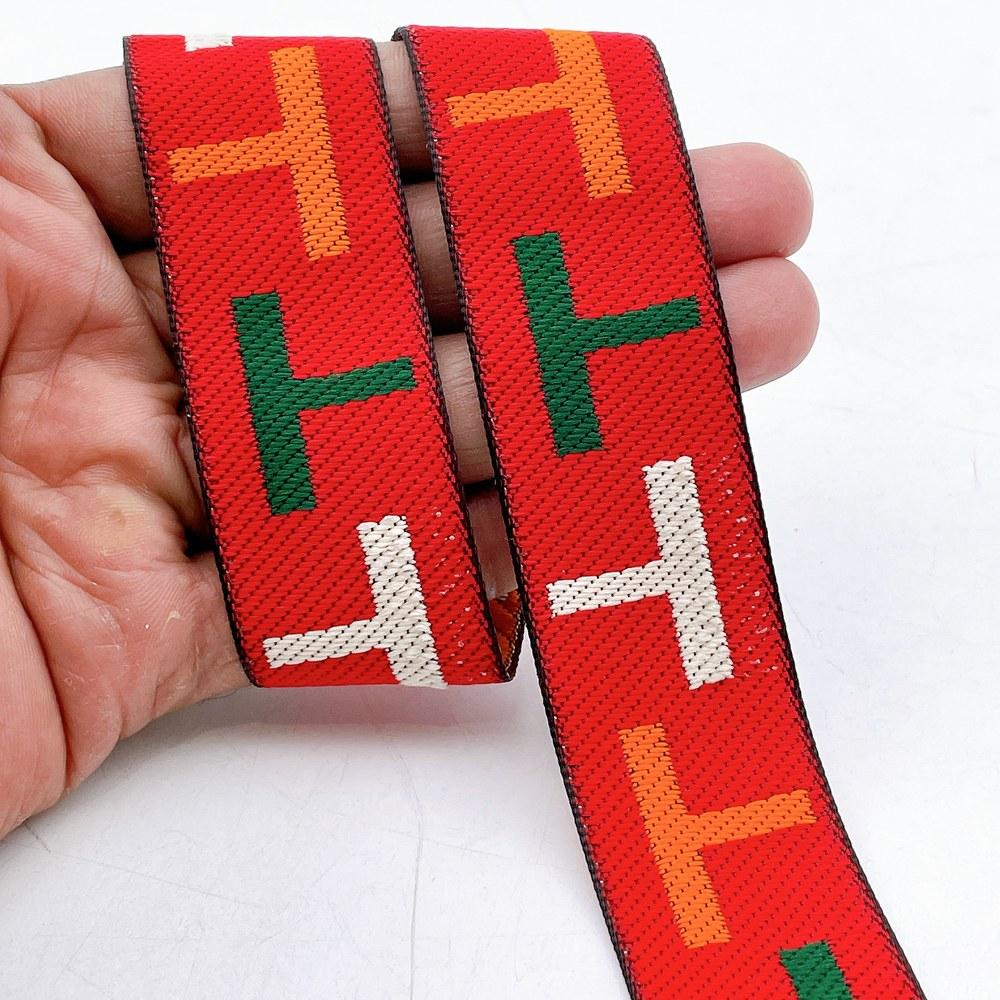 28mm Sporty Geometric Jacquard Ribbon Trim - Woven 'T' Pattern Tape for Apparel and Bag Straps, shown on white cotton